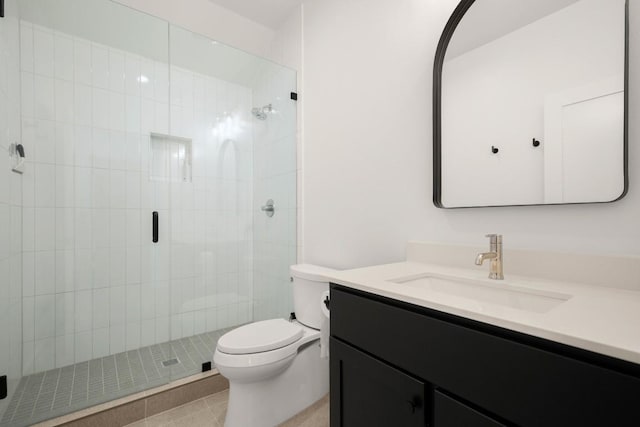 bathroom featuring a stall shower, toilet, and vanity