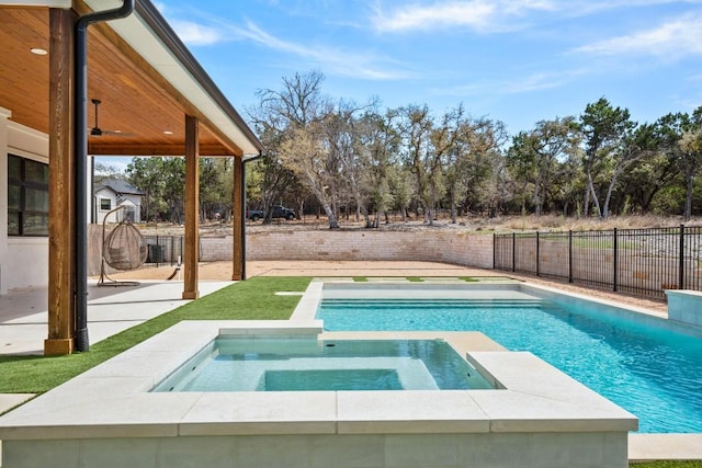 view of swimming pool featuring a pool with connected hot tub, a ceiling fan, a patio, and fence