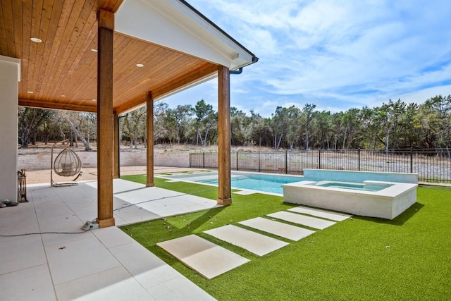 view of yard with an in ground hot tub, fence, a fenced in pool, and a patio