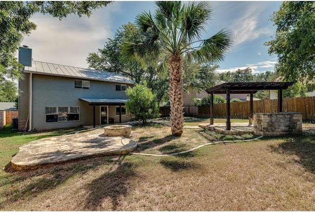 view of yard featuring fence, a fire pit, a pergola, and a patio area