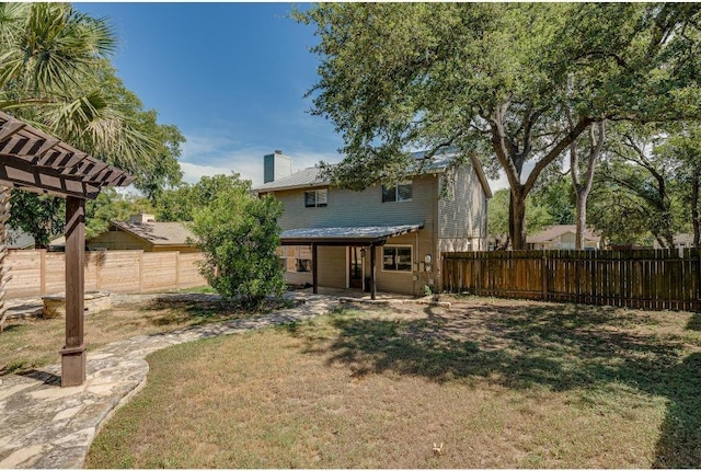 rear view of house featuring a patio, a fenced backyard, a pergola, a chimney, and a lawn