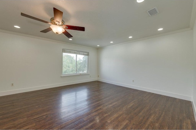 unfurnished room with visible vents, baseboards, crown molding, and dark wood-type flooring