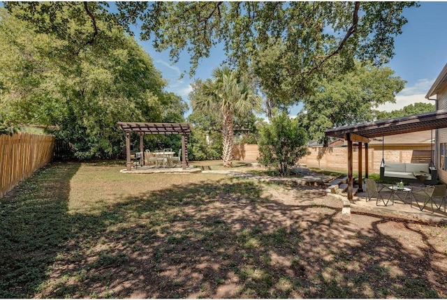 view of yard featuring a patio area, a fenced backyard, and a pergola