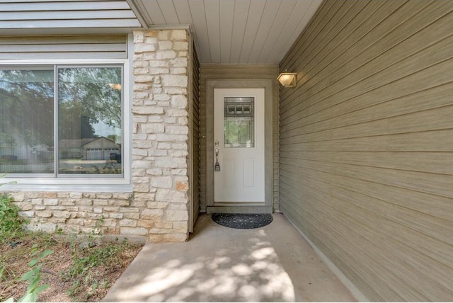 view of exterior entry featuring stone siding