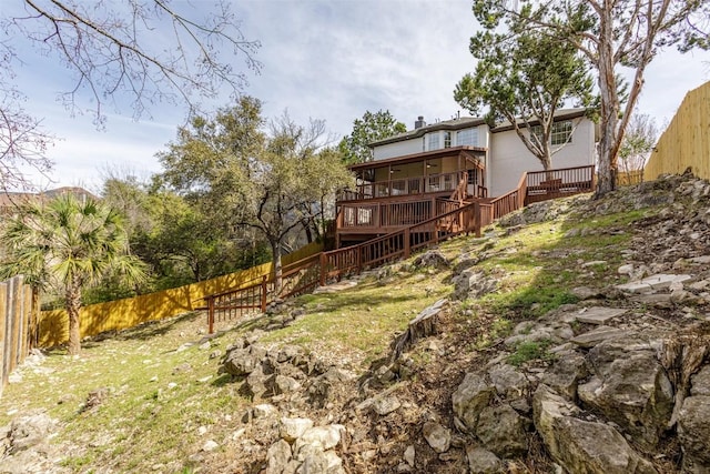 view of yard with a deck and a fenced backyard