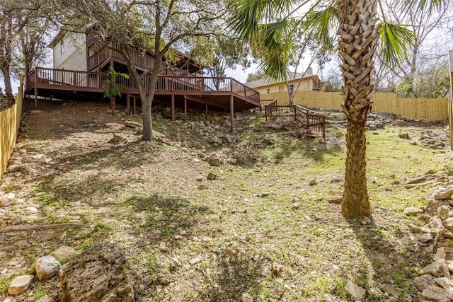 view of yard with a deck and fence