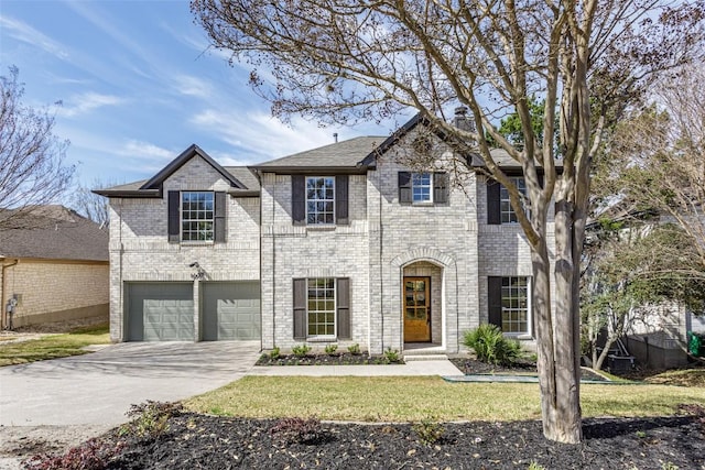 view of front facade featuring an attached garage, brick siding, and driveway