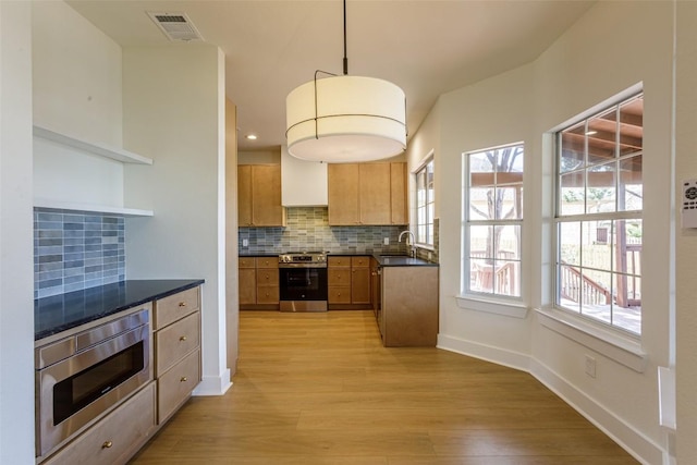 kitchen featuring visible vents, open shelves, tasteful backsplash, dark countertops, and stainless steel appliances