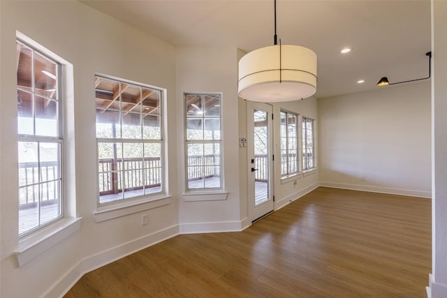 doorway with recessed lighting, wood finished floors, and baseboards