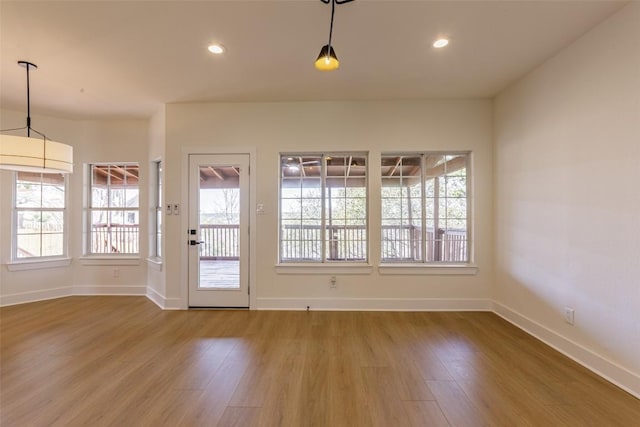 interior space featuring a wealth of natural light, wood finished floors, and recessed lighting