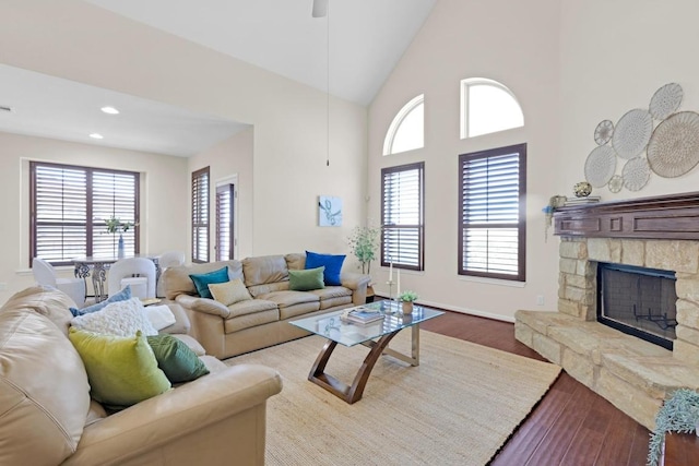 living area with ceiling fan, recessed lighting, a fireplace, wood finished floors, and high vaulted ceiling