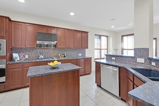 kitchen featuring dark stone countertops, tasteful backsplash, recessed lighting, appliances with stainless steel finishes, and light tile patterned floors