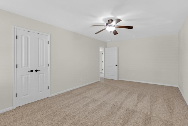 empty room with baseboards, carpet, and a ceiling fan