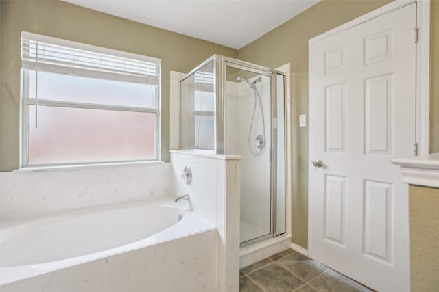 full bath with tile patterned floors, a bath, and a stall shower