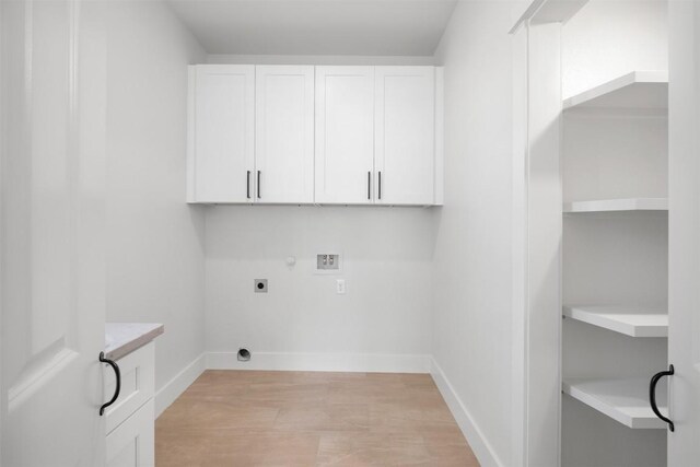 113 Eaglenest Ct, Smithville, TX 78957 - laundry area featuring hookup for an electric dryer, light wood-style flooring, washer hookup, cabinet space, and gas dryer hookup