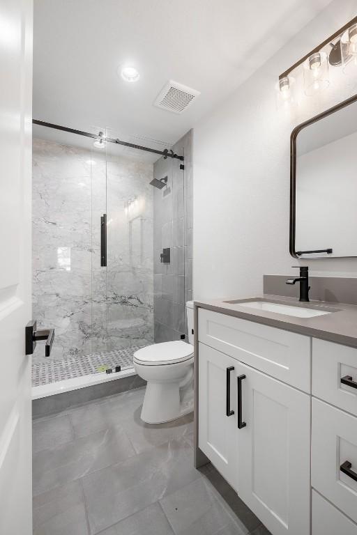 113 Eaglenest Ct, Smithville, TX 78957 - bathroom featuring vanity, a marble finish shower, and marble look tiles