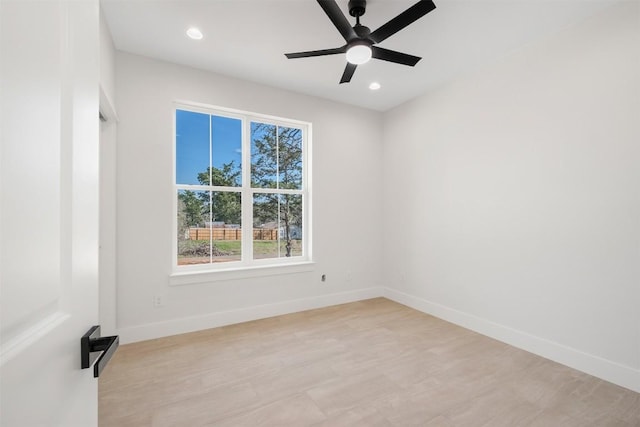 spare room with recessed lighting, a ceiling fan, light wood-type flooring, and baseboards