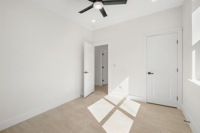 unfurnished bedroom featuring light wood finished floors, recessed lighting, a ceiling fan, and baseboards