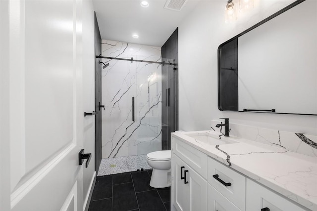 bathroom featuring a marble finish shower, visible vents, toilet, and vanity