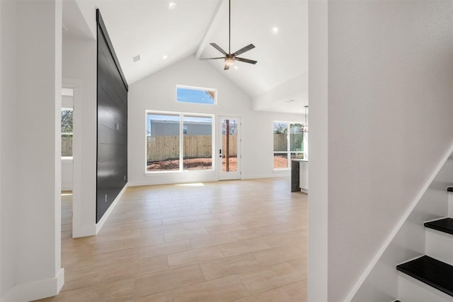 interior space with visible vents, baseboards, and high vaulted ceiling