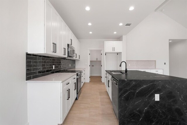 113 Eaglenest Ct, Smithville, TX 78957 - kitchen with stainless steel appliances, decorative backsplash, stone countertops, recessed lighting, and white cabinetry