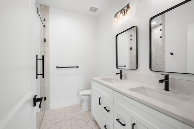 bathroom with a sink, visible vents, and a shower stall