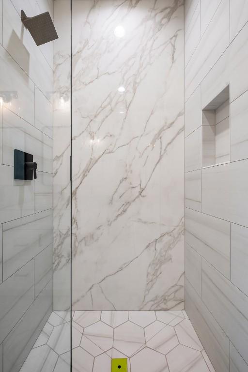 bathroom with a tile shower