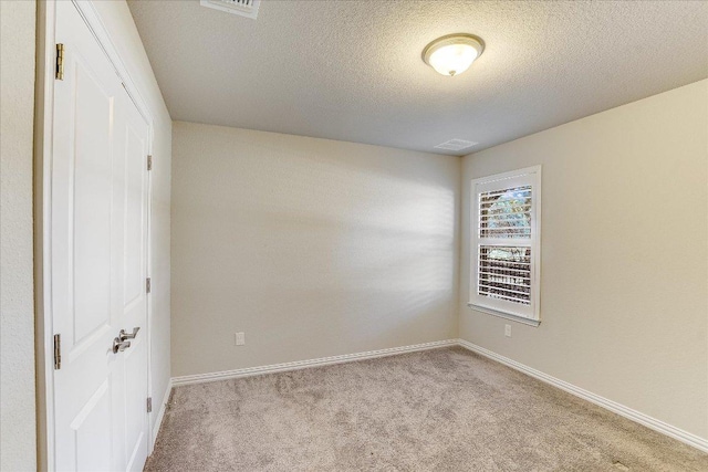 unfurnished bedroom with visible vents, a textured ceiling, baseboards, and carpet floors