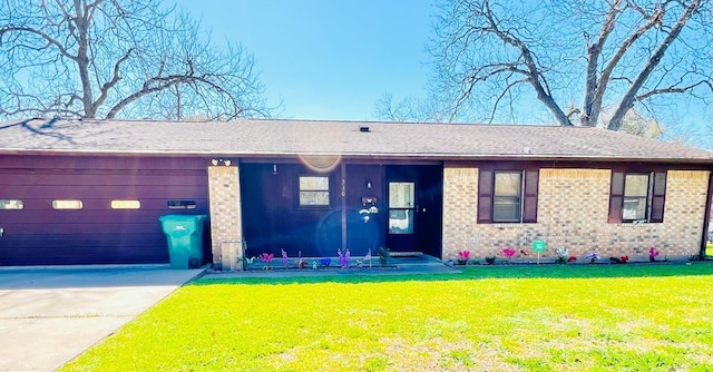 single story home featuring brick siding, concrete driveway, and a front lawn