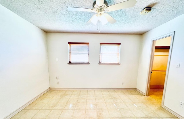 empty room featuring baseboards, a textured ceiling, and ceiling fan