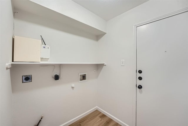 laundry room with gas dryer hookup, light wood finished floors, hookup for an electric dryer, hookup for a washing machine, and laundry area