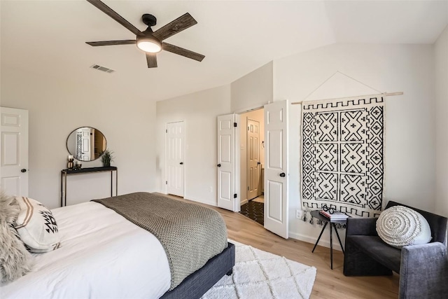 bedroom with ceiling fan, baseboards, visible vents, and light wood-type flooring