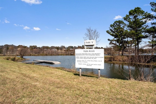 view of dock featuring a yard and a water view