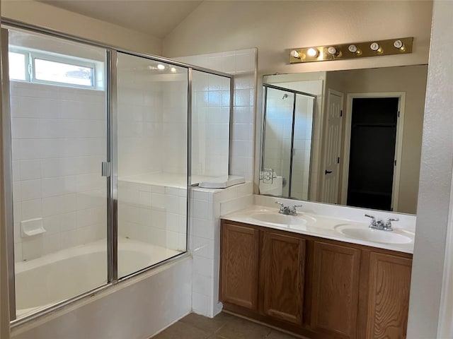 bathroom featuring a sink, bath / shower combo with glass door, tile patterned floors, and vaulted ceiling