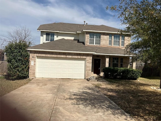 traditional-style house with brick siding, fence, concrete driveway, roof with shingles, and an attached garage