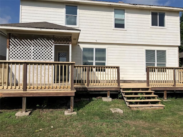 rear view of property with a lawn and a deck
