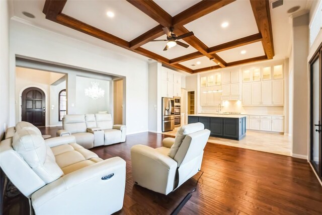 living room with wood-type flooring, beamed ceiling, baseboards, ceiling fan, and coffered ceiling