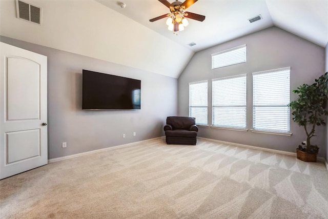 sitting room with visible vents, baseboards, carpet, and lofted ceiling