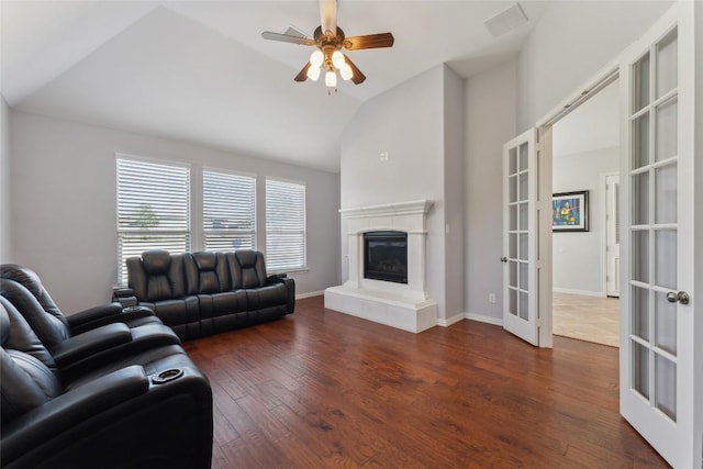 living room with ceiling fan, french doors, visible vents, wood finished floors, and a glass covered fireplace
