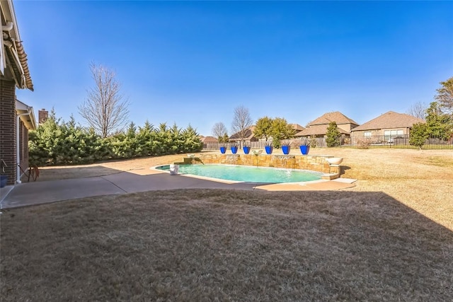 view of swimming pool featuring a lawn, fence, a fenced in pool, and a patio