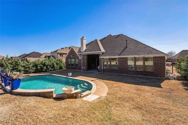 view of pool featuring a yard, a patio, a fenced in pool, and fence