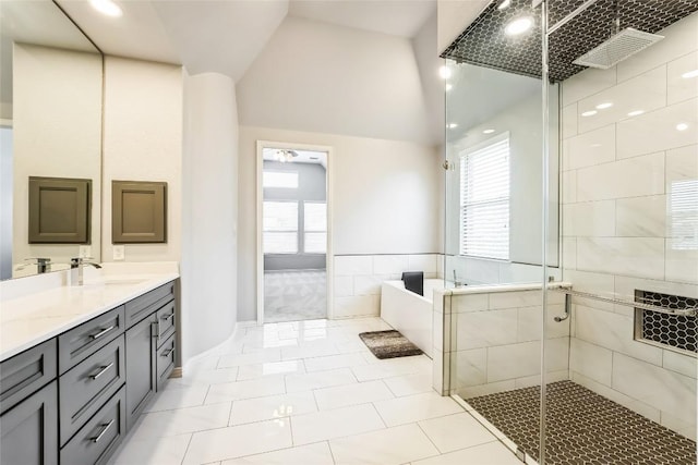 bathroom with a garden tub, tile patterned flooring, vanity, lofted ceiling, and a shower stall