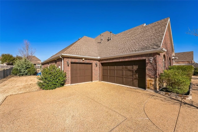 view of property exterior with a garage, brick siding, and a shingled roof