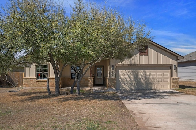 view of front of home featuring board and batten siding, concrete driveway, and a garage