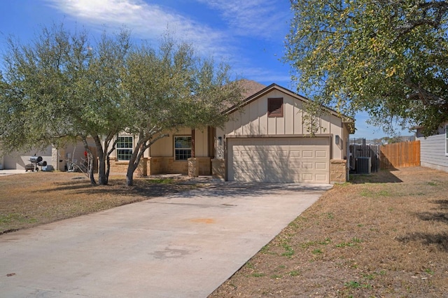 single story home featuring an attached garage, driveway, and fence