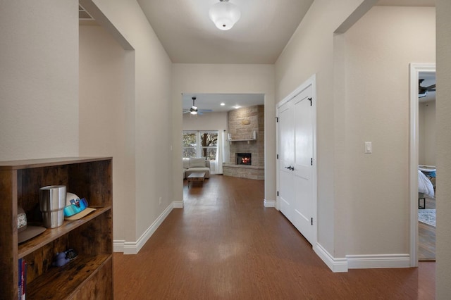 hall with wood finished floors and baseboards