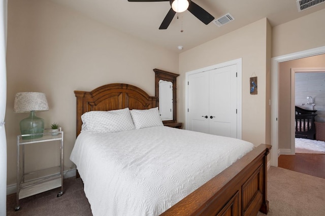 carpeted bedroom with a closet, visible vents, and ceiling fan