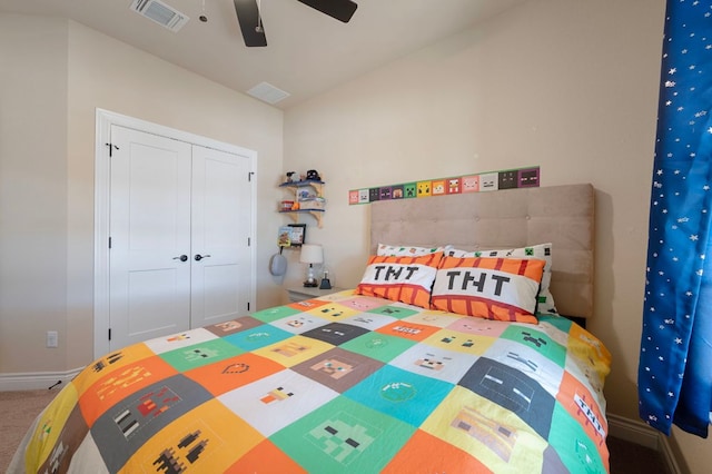 carpeted bedroom with a closet, visible vents, baseboards, and ceiling fan