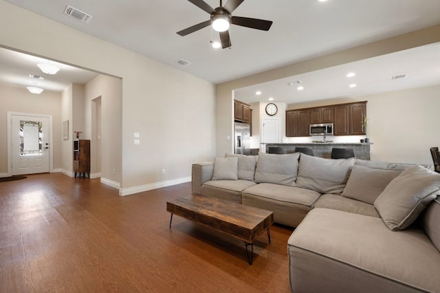 living area featuring visible vents, dark wood-type flooring, baseboards, ceiling fan, and recessed lighting