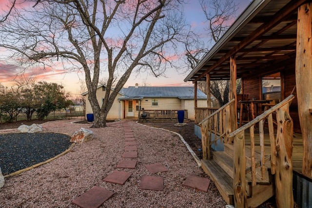 yard at dusk featuring a deck